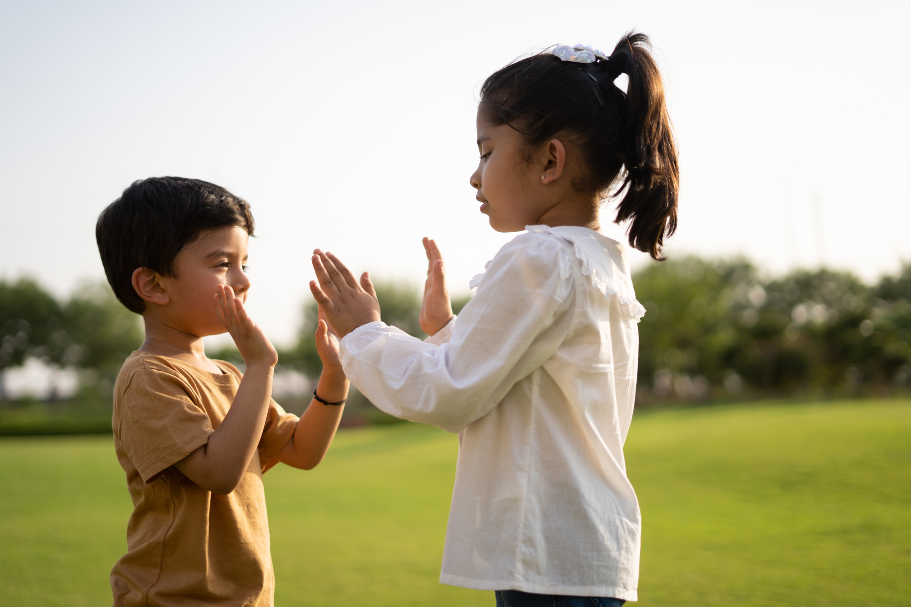 Little Boy and Girl Playing Together in the Park